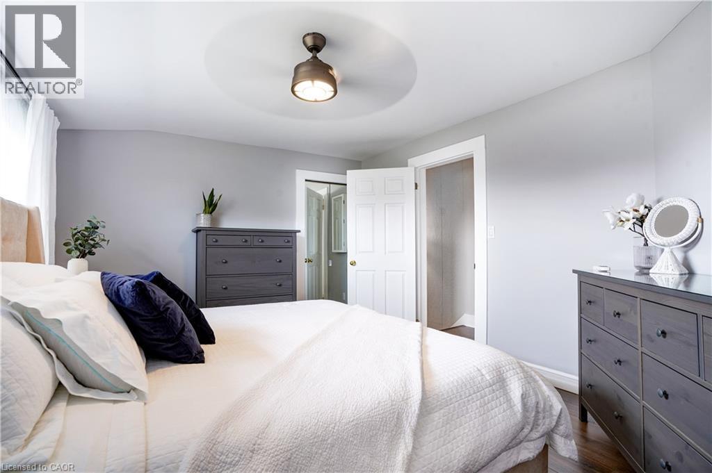 Bedroom featuring dark wood finished floors, a ceiling fan, and a closet - 23247 Beattie Line, Elgin, ON - Indoor Photo Showing Bedroom