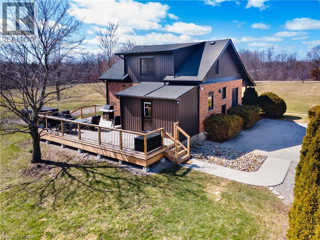 Back of house with a yard, a deck, and a shingled roof - 23247 Beattie Line, Elgin, ON - Outdoor With Deck Patio Veranda