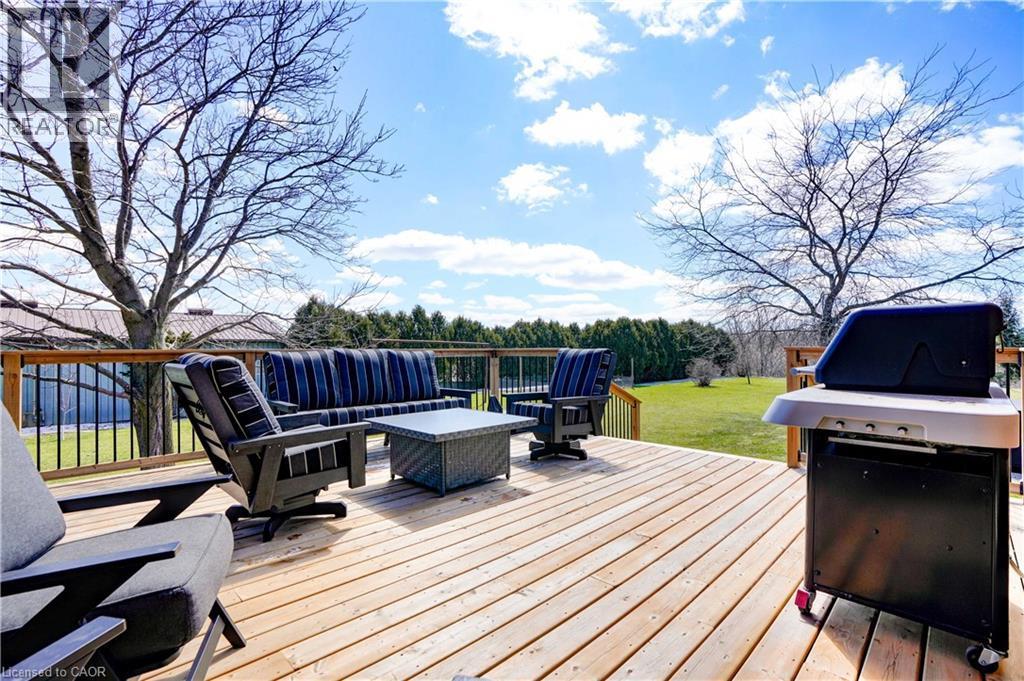 Wooden deck with area for grilling, outdoor lounge area, and a yard - 23247 Beattie Line, Elgin, ON - Outdoor With Deck Patio Veranda