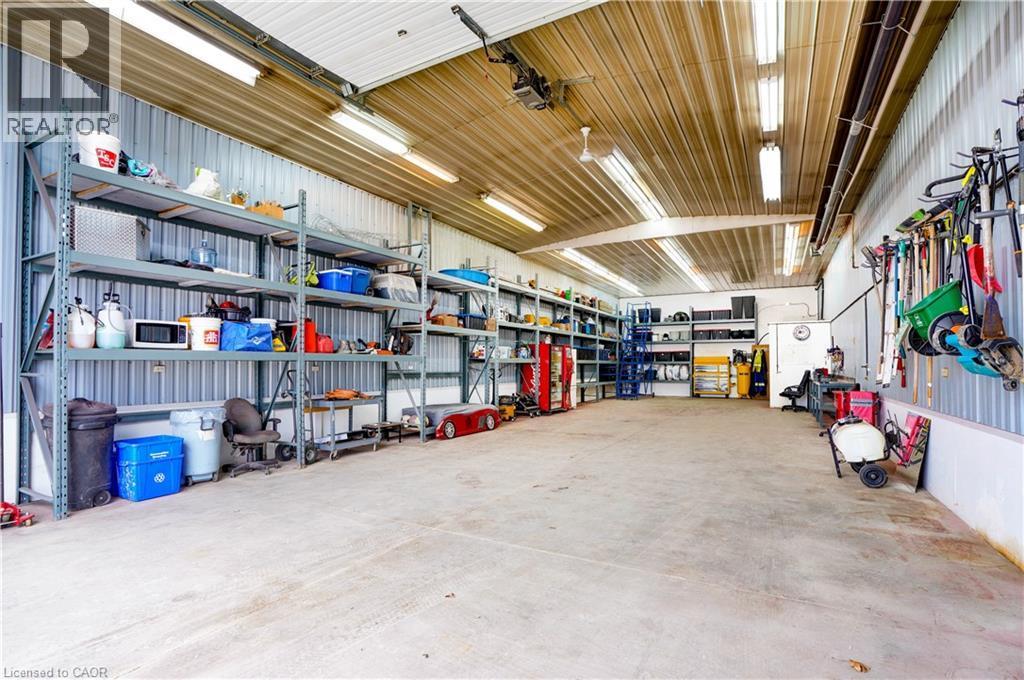 Garage with metal wall and a garage door opener - 23247 Beattie Line, Elgin, ON - Indoor Photo Showing Garage