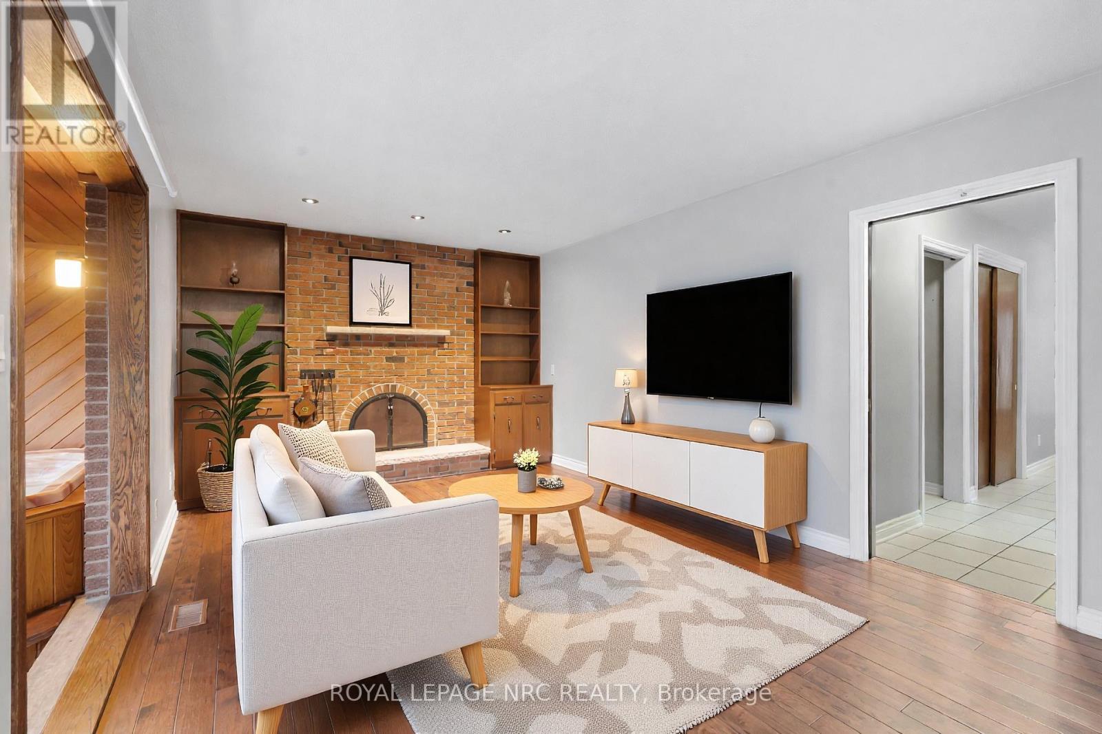 Virtually staged - 64 Adel Drive, St. Catharines (Carlton/Bunting), ON - Indoor Photo Showing Living Room With Fireplace