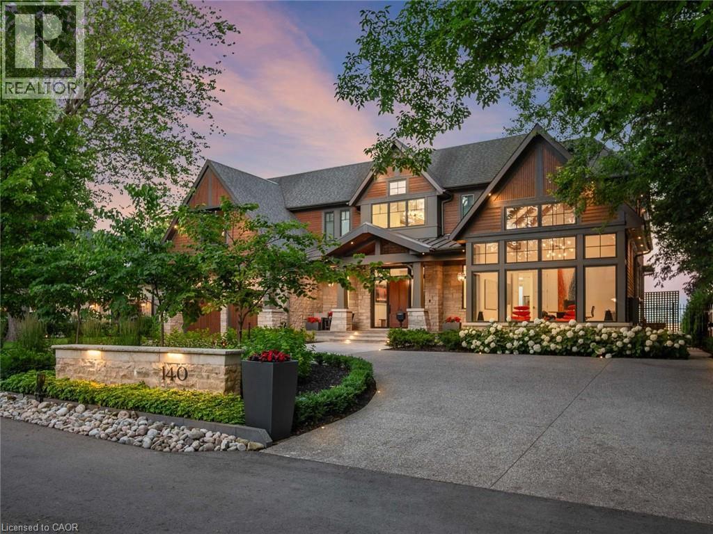 Expansive modern residence featuring a multi-gabled roofline and a mix of wood siding and stone accents - 140 Secord Lane, Burlington, ON - Outdoor