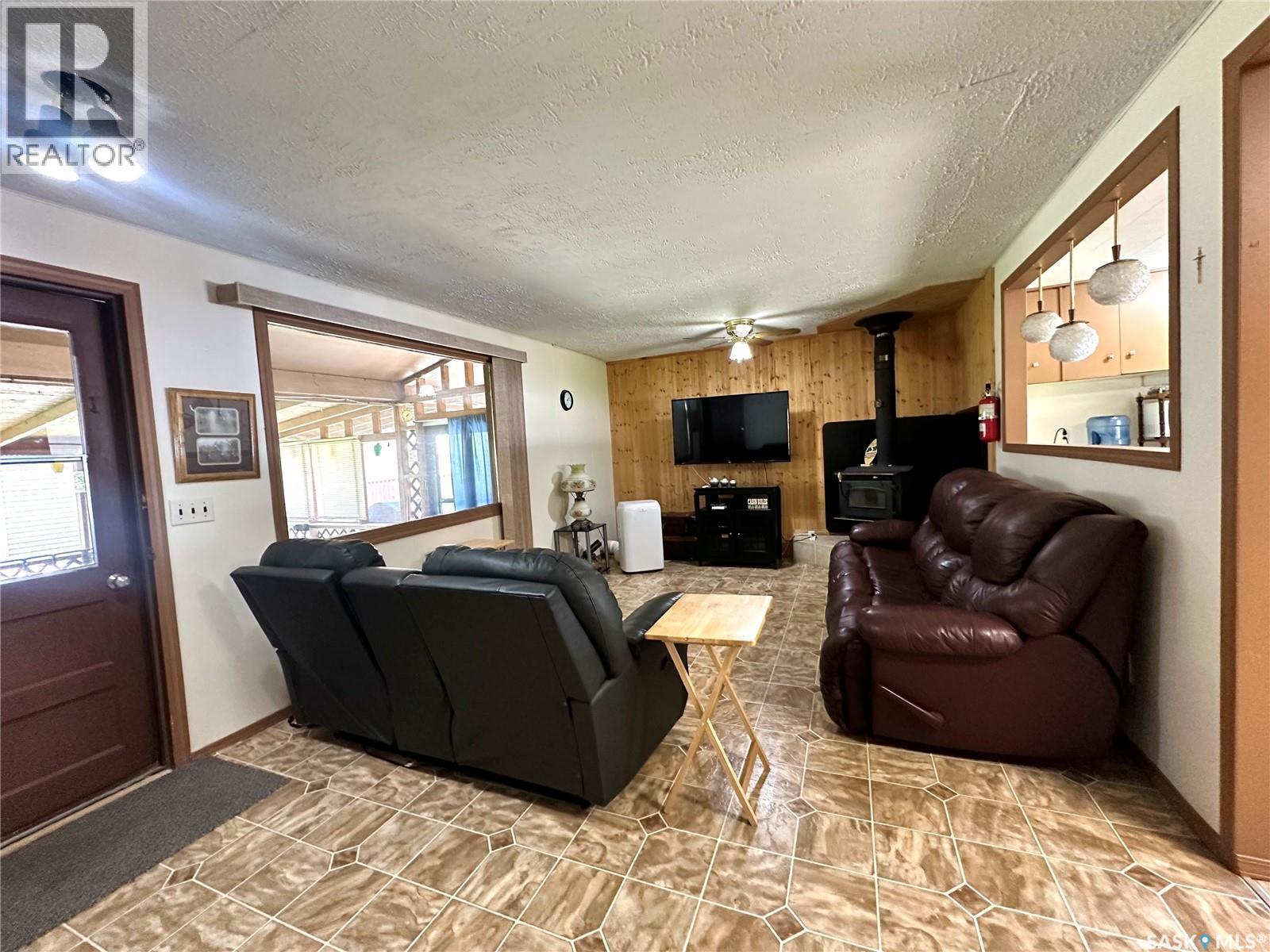 122 Pine Street, Chitek Lake, SK - Indoor Photo Showing Living Room With Fireplace