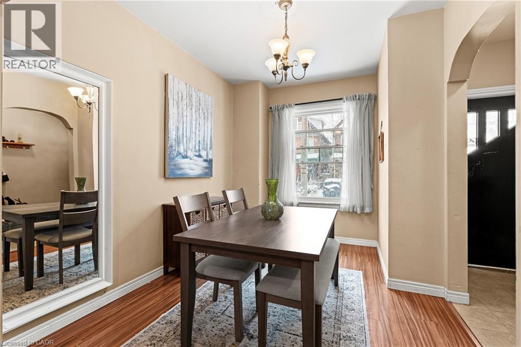 Dining room with arched walkways, suspended lighting, and light wood-type flooring - 78 Clyde Street, Hamilton, ON - Indoor Photo Showing Dining Room