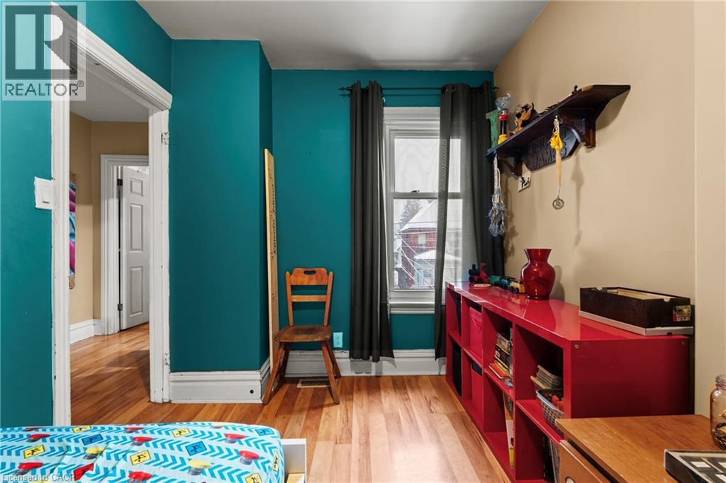 Bedroom featuring light wood-style flooring and baseboards - 78 Clyde Street, Hamilton, ON - Indoor