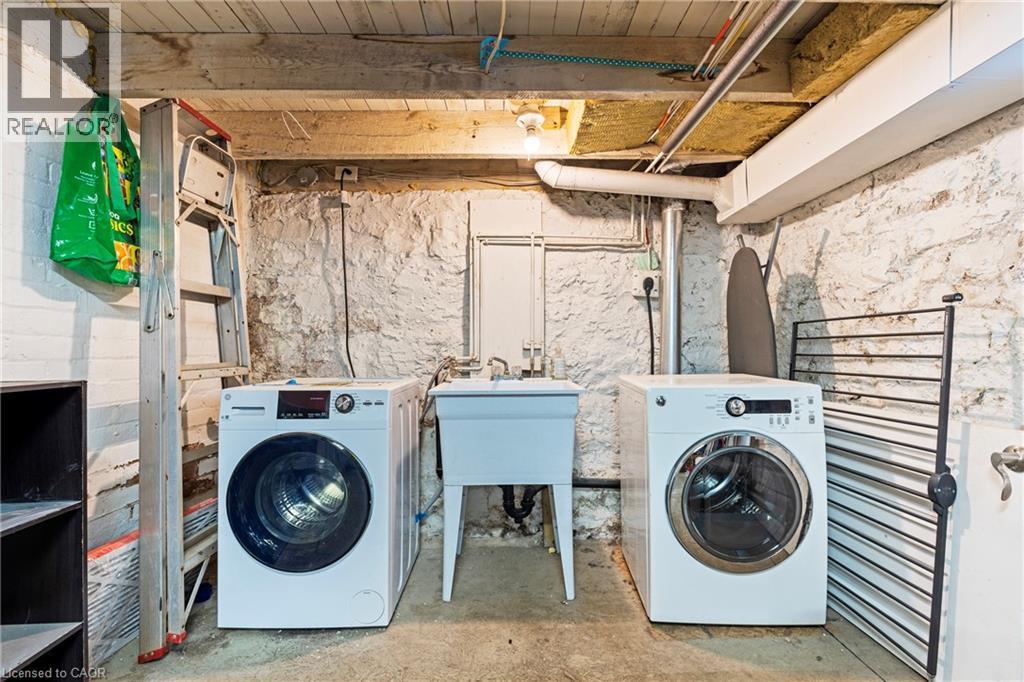 Laundry area featuring washer and clothes dryer, concrete floors, and wooden ceiling - 78 Clyde Street, Hamilton, ON - Indoor Photo Showing Laundry Room