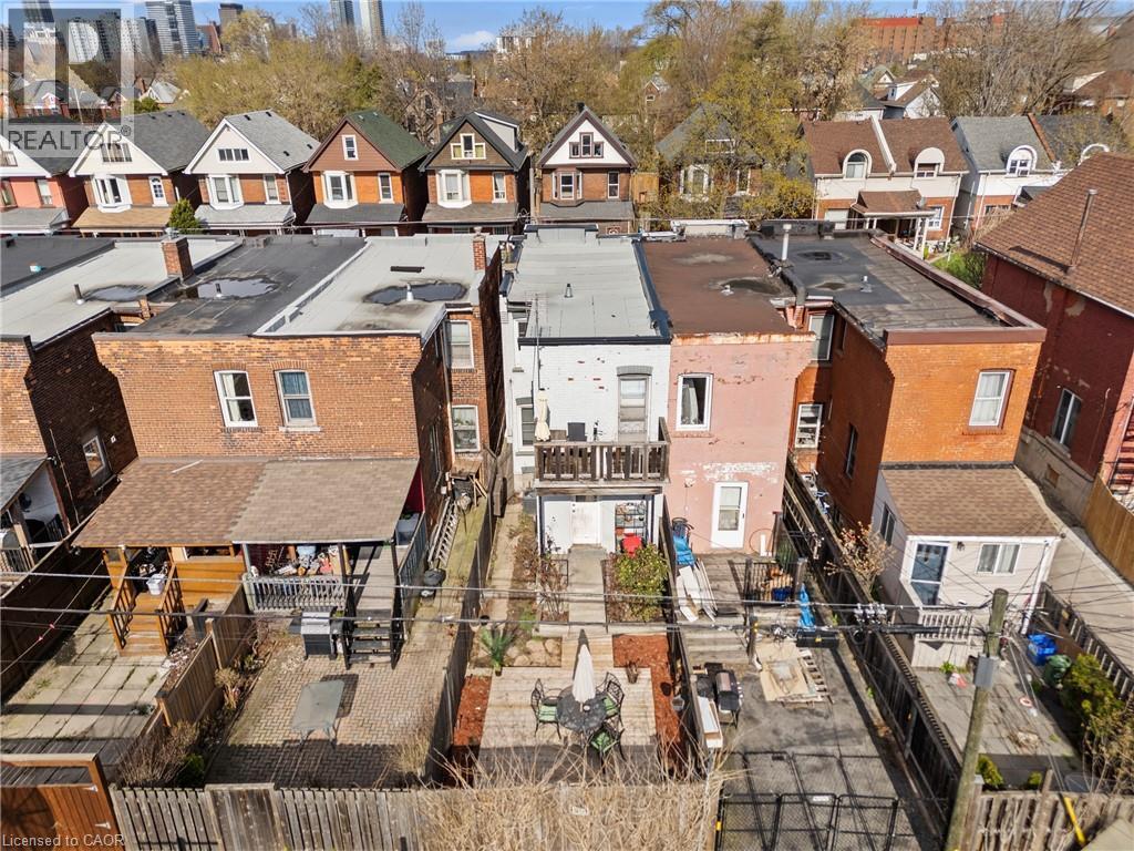 Rear elevations of properties featuring brick construction and multiple decks - 78 Clyde Street, Hamilton, ON - Outdoor