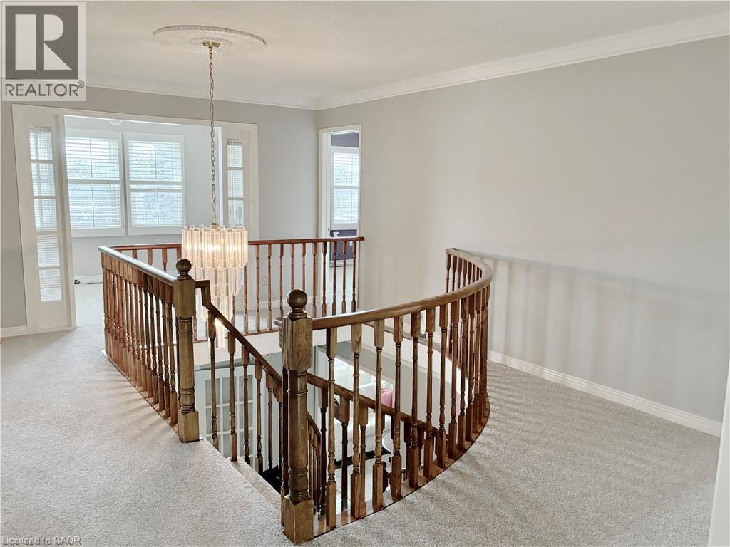 Corridor featuring a chandelier, an upstairs landing, carpet floors, and ornamental molding - 2056 Hadfield Court, Burlington, ON - Indoor Photo Showing Other Room