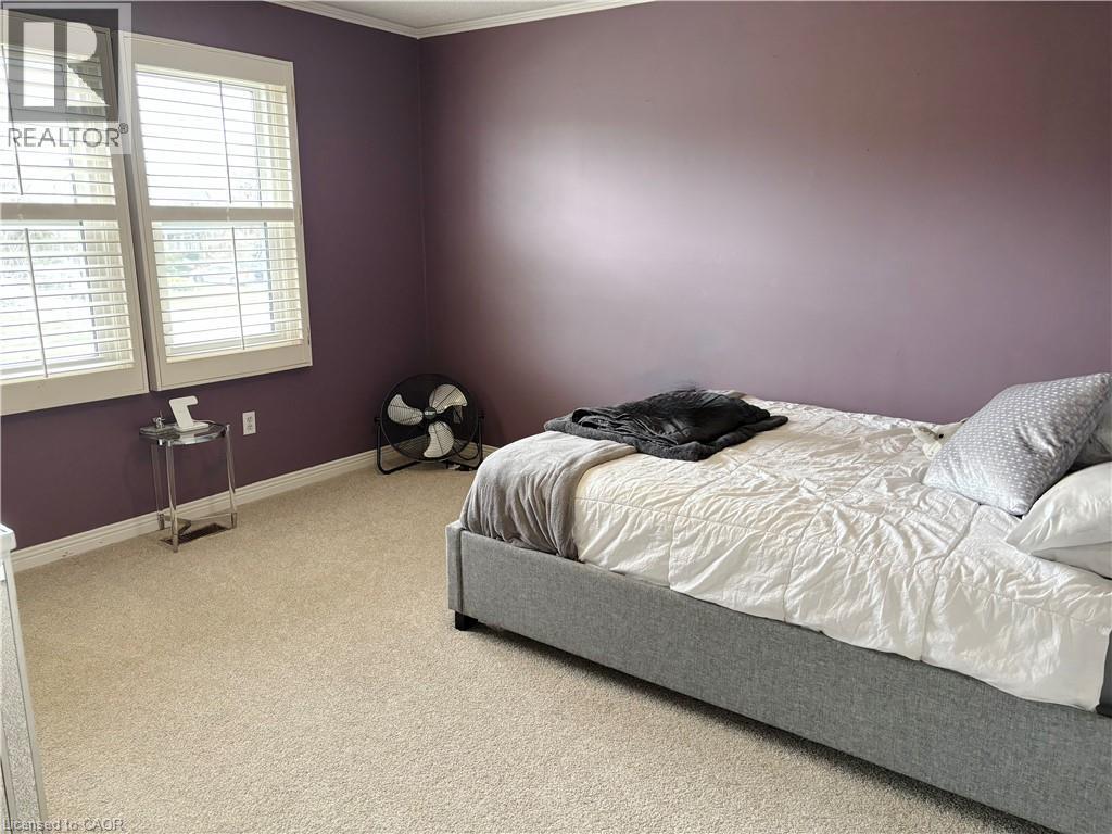 Bedroom featuring light carpet and ornamental molding - 2056 Hadfield Court, Burlington, ON - Indoor Photo Showing Bedroom
