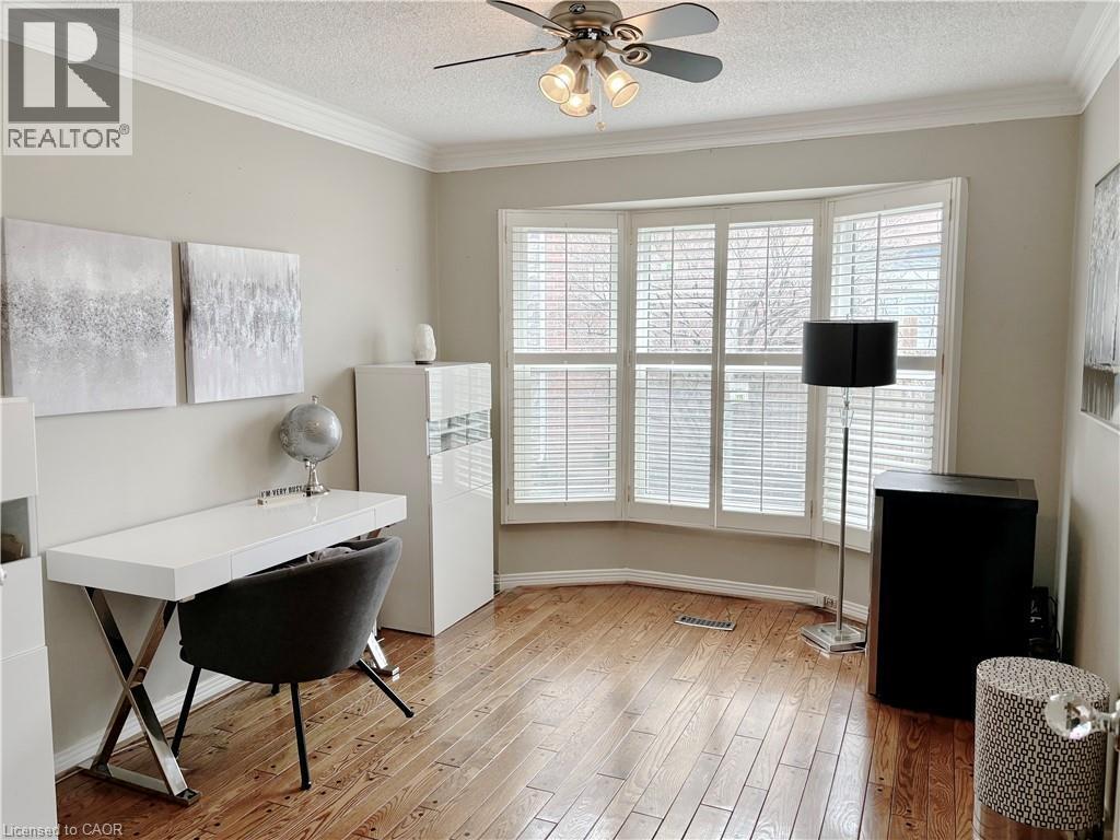 Office with light wood-style floors, a ceiling fan, ornamental molding, and a textured ceiling - 2056 Hadfield Court, Burlington, ON - Indoor