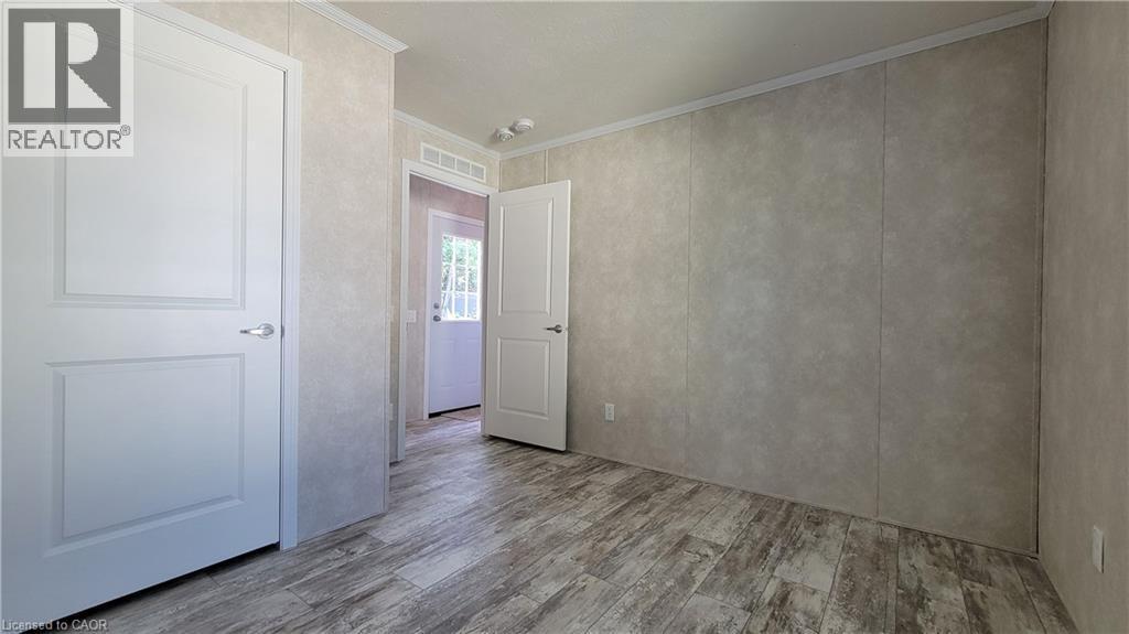 Spare room with ornamental molding and wood finished floors - 24 Macpherson Crescent, Flamborough, ON - Indoor Photo Showing Other Room
