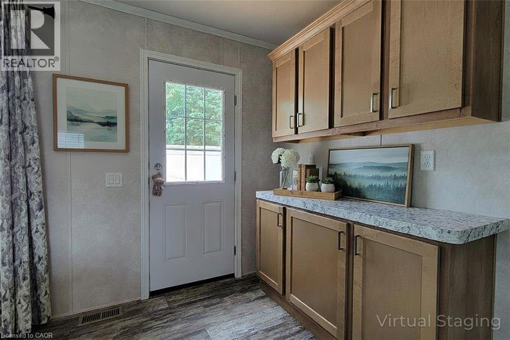 Entryway with wood finished floors and crown molding - 77 Park Lane, Flamborough, ON - Indoor Photo Showing Kitchen
