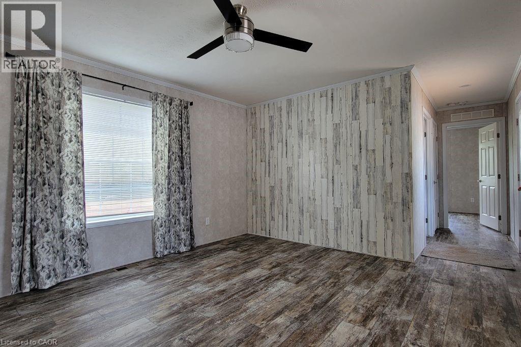 Empty room with wood finished floors, ornamental molding, and ceiling fan - 77 Park Lane, Flamborough, ON - Indoor Photo Showing Other Room