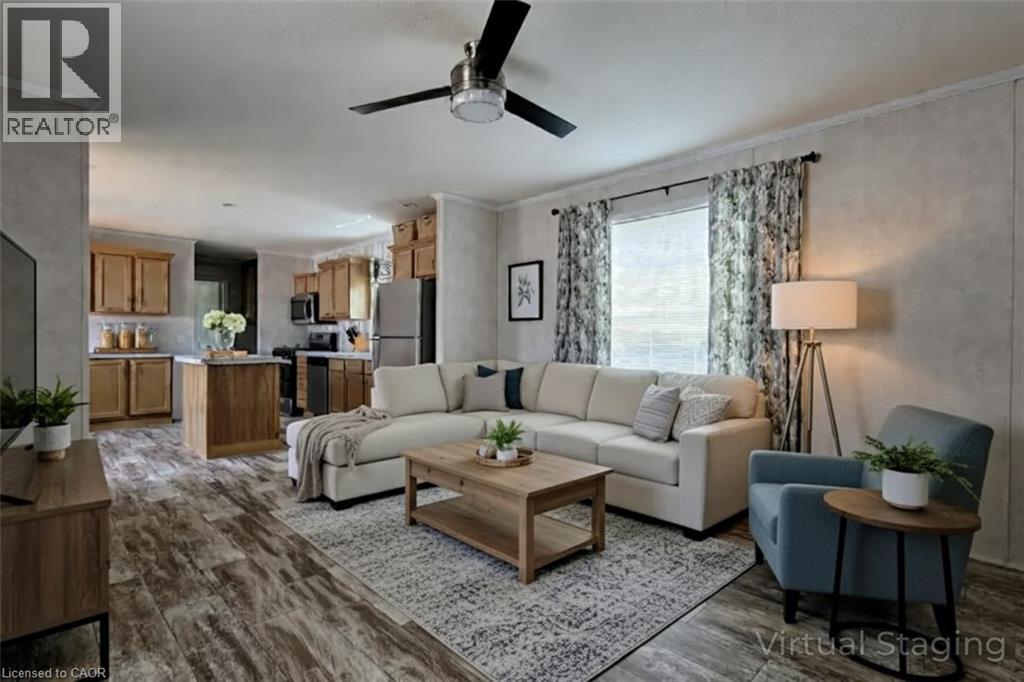 Living area featuring ornamental molding, ceiling fan, and dark wood-style flooring - 77 Park Lane, Flamborough, ON - Indoor Photo Showing Living Room