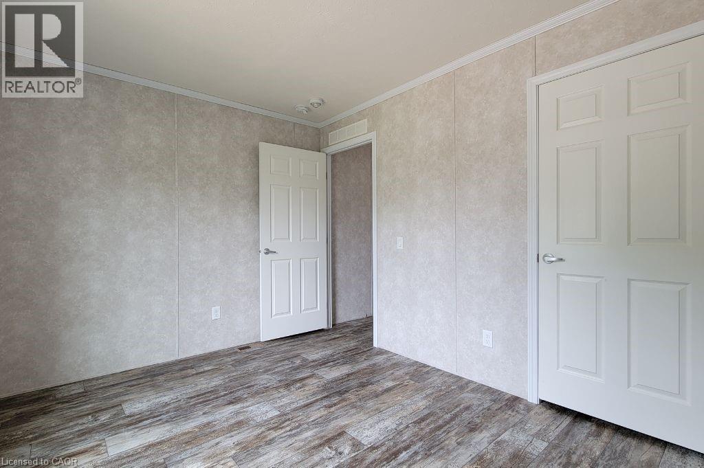Unfurnished room with wood finished floors and ornamental molding - 77 Park Lane, Flamborough, ON - Indoor Photo Showing Other Room