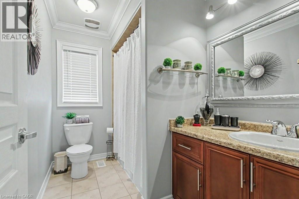 Full bathroom featuring ornamental molding, a shower with curtain, vanity, and light tile patterned floors - 284 Normanhurst Avenue, Hamilton, ON - Indoor Photo Showing Bathroom