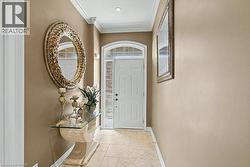 Foyer with ornamental molding and baseboards -