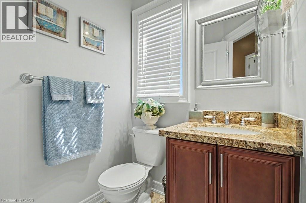 Half bathroom featuring toilet and vanity - 284 Normanhurst Avenue, Hamilton, ON - Indoor Photo Showing Bathroom