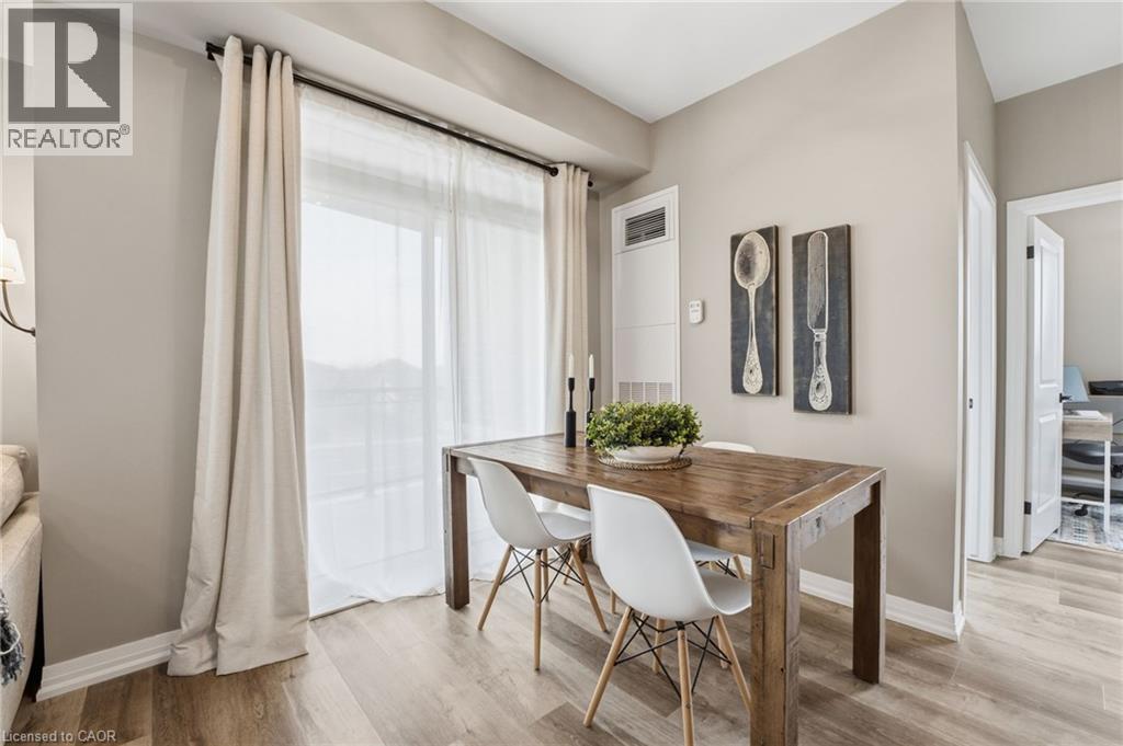 Dining space featuring baseboards and light wood finished floors - 120 Springvalley Crescent Unit# 203, Hamilton, ON - Indoor Photo Showing Dining Room