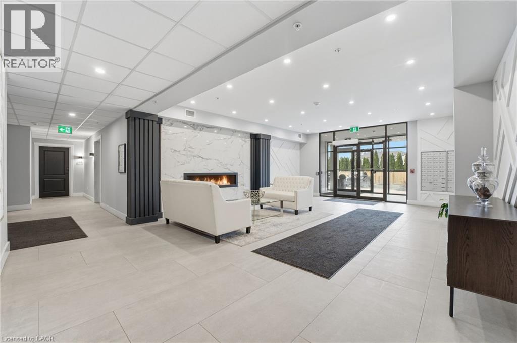 Lobby featuring recessed lighting and expansive windows - 120 Springvalley Crescent Unit# 203, Hamilton, ON - Indoor Photo Showing Other Room