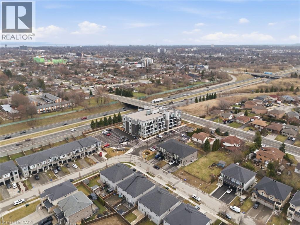 Aerial view of property's location featuring a main thoroughfare and nearby suburban area - 120 Springvalley Crescent Unit# 203, Hamilton, ON - Outdoor With View