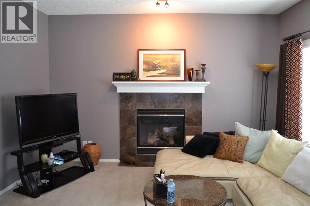 209 Lakeview Inlet, Chestermere, AB - Indoor Photo Showing Living Room With Fireplace