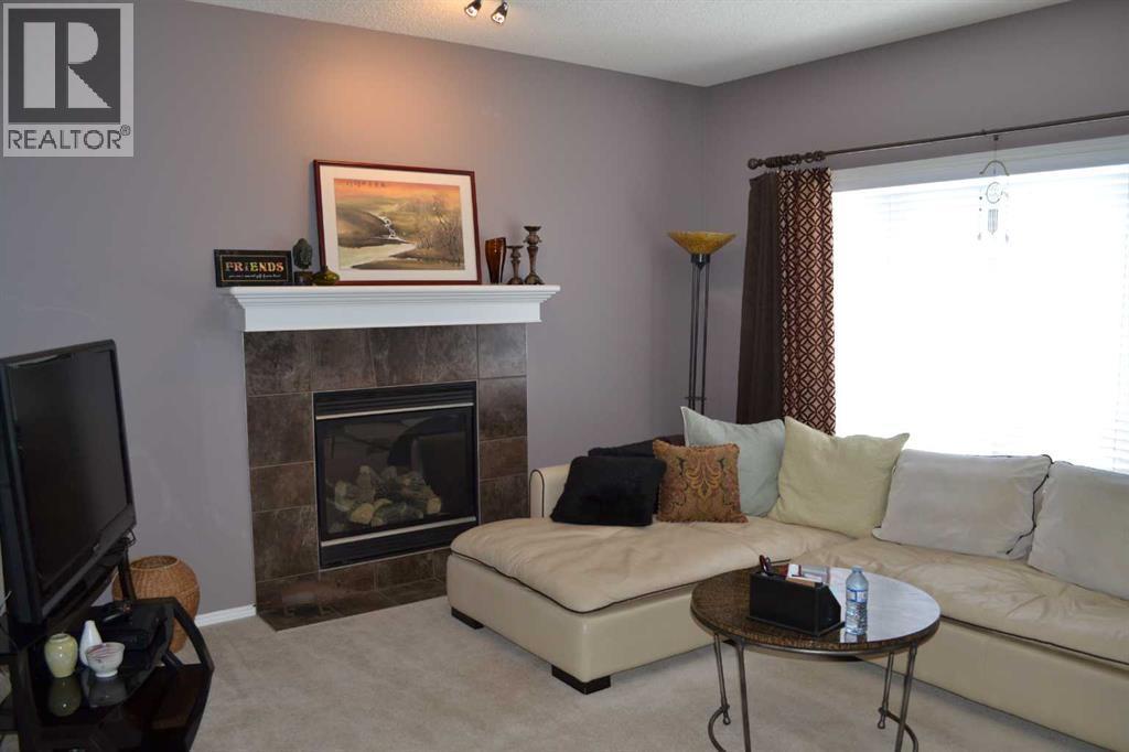 209 Lakeview Inlet, Chestermere, AB - Indoor Photo Showing Living Room With Fireplace
