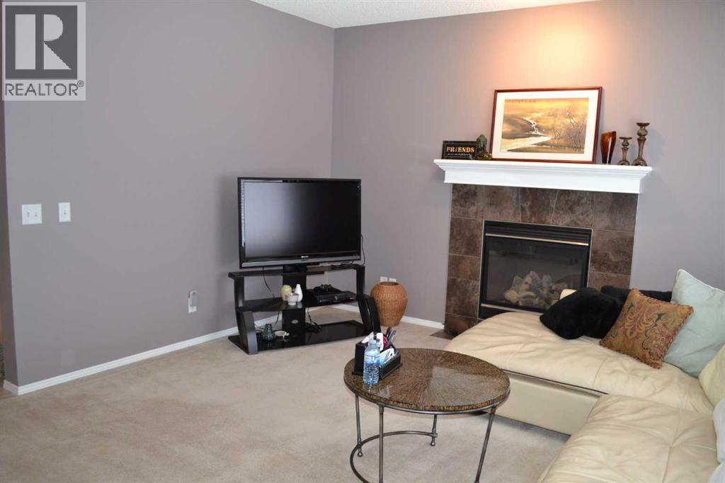209 Lakeview Inlet, Chestermere, AB - Indoor Photo Showing Living Room With Fireplace