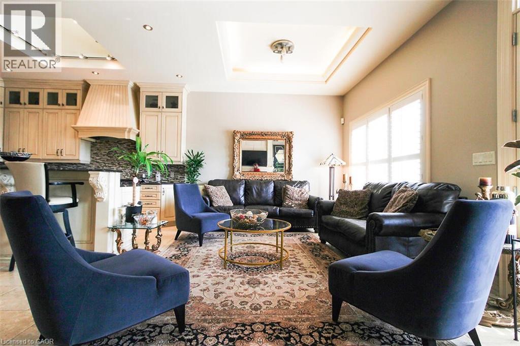 Living room featuring a raised ceiling, recessed lighting, and a skylight - 205 Paige Place, Kitchener, ON - Indoor Photo Showing Living Room With Fireplace