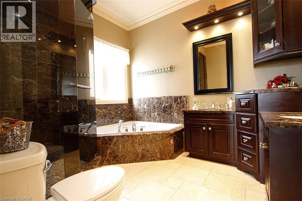 Bathroom with a shower stall, vanity, a bath, and ornamental molding - 205 Paige Place, Kitchener, ON - Indoor Photo Showing Bathroom