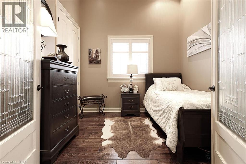 Bedroom featuring dark wood-style flooring and baseboards - 205 Paige Place, Kitchener, ON - Indoor Photo Showing Bedroom