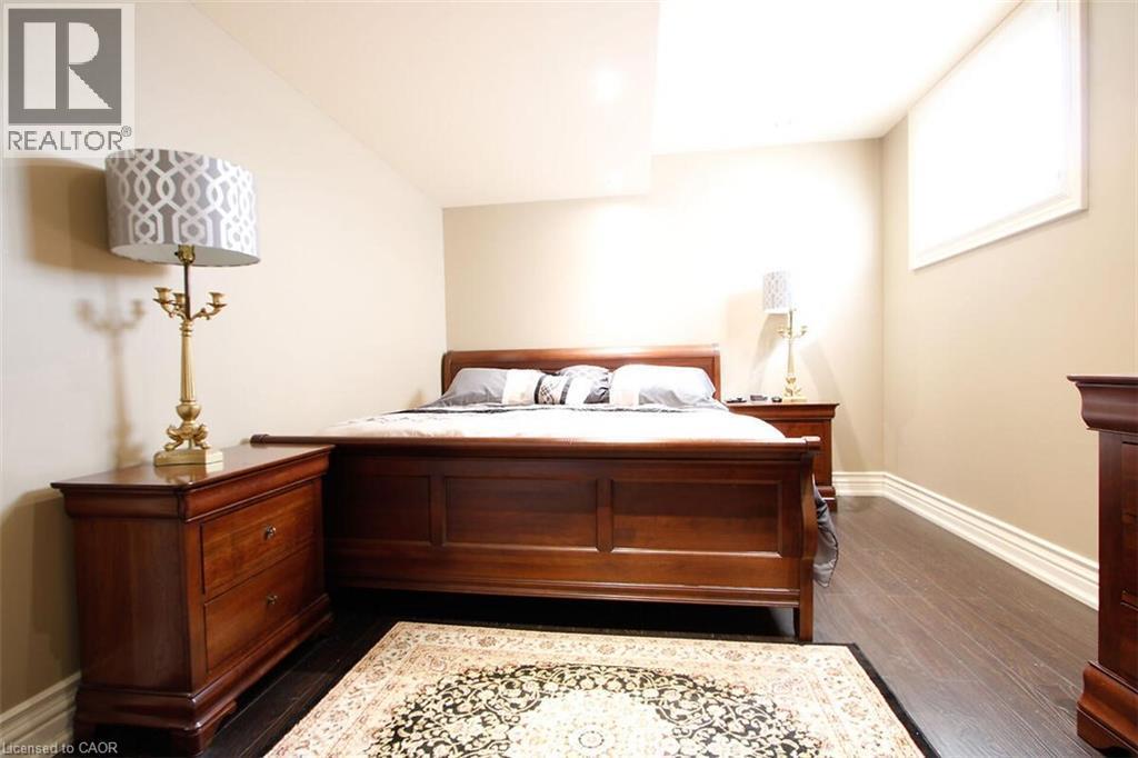 Bedroom with baseboards and dark wood-type flooring - 205 Paige Place, Kitchener, ON - Indoor Photo Showing Bedroom
