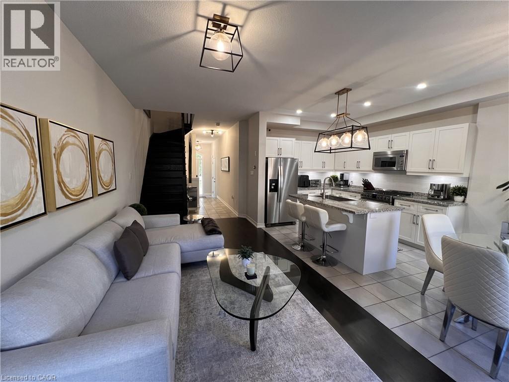 Living room with light tile patterned floors and recessed lighting - 1165 West 5Th Street, Hamilton, ON - Indoor