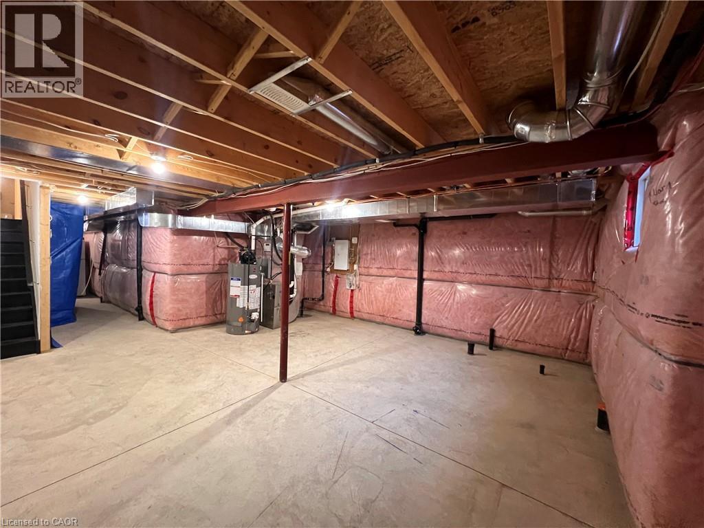 Unfinished basement with gas water heater, heating unit, and electric panel - 1165 West 5Th Street, Hamilton, ON - Indoor Photo Showing Basement