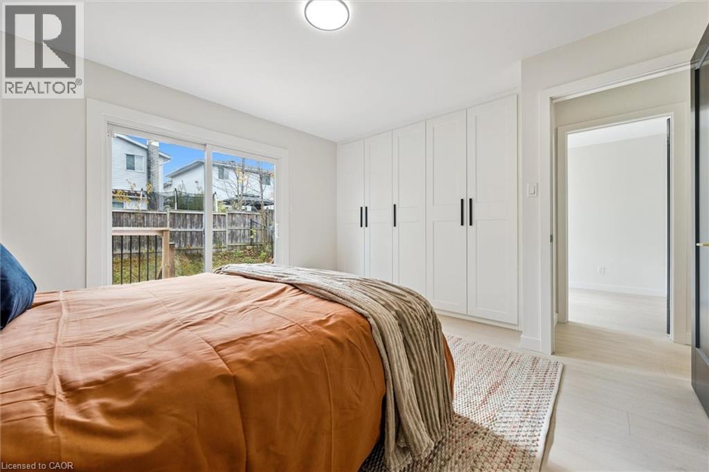 Bedroom with access to outside and light wood-style flooring - 459 Drummerhill Crescent, Waterloo, ON - Indoor Photo Showing Bedroom