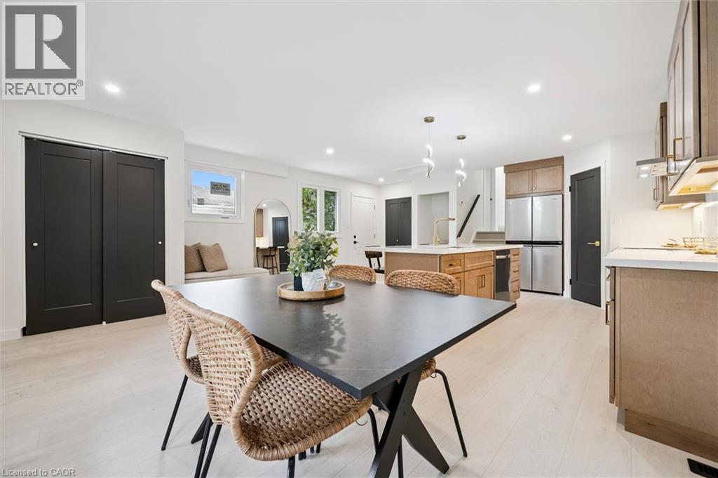 Dining space featuring recessed lighting, arched walkways, and light wood finished floors - 459 Drummerhill Crescent, Waterloo, ON - Indoor Photo Showing Other Room