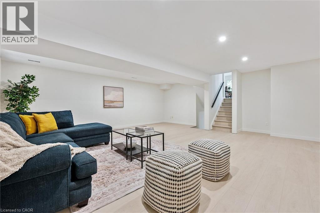 Living room featuring recessed lighting, light wood-style flooring, and stairs - 459 Drummerhill Crescent, Waterloo, ON - Indoor