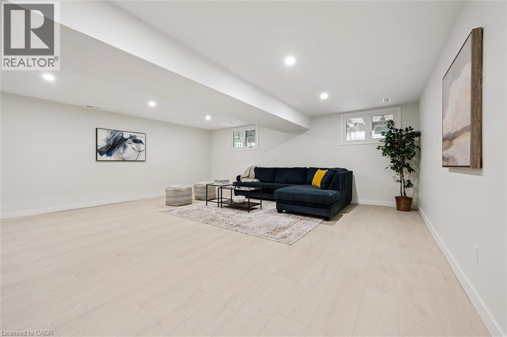 Living room with recessed lighting and light wood-style flooring - 459 Drummerhill Crescent, Waterloo, ON - Indoor