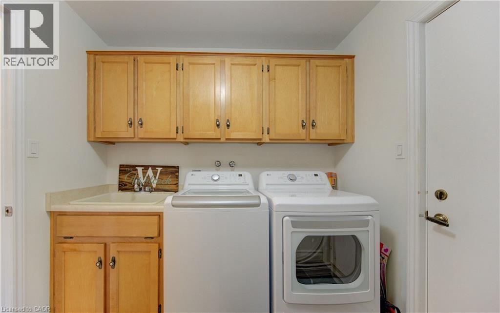 Laundry area featuring cabinet space and independent washer and dryer - 306 Roxton Drive, Waterloo, ON - Indoor Photo Showing Laundry Room