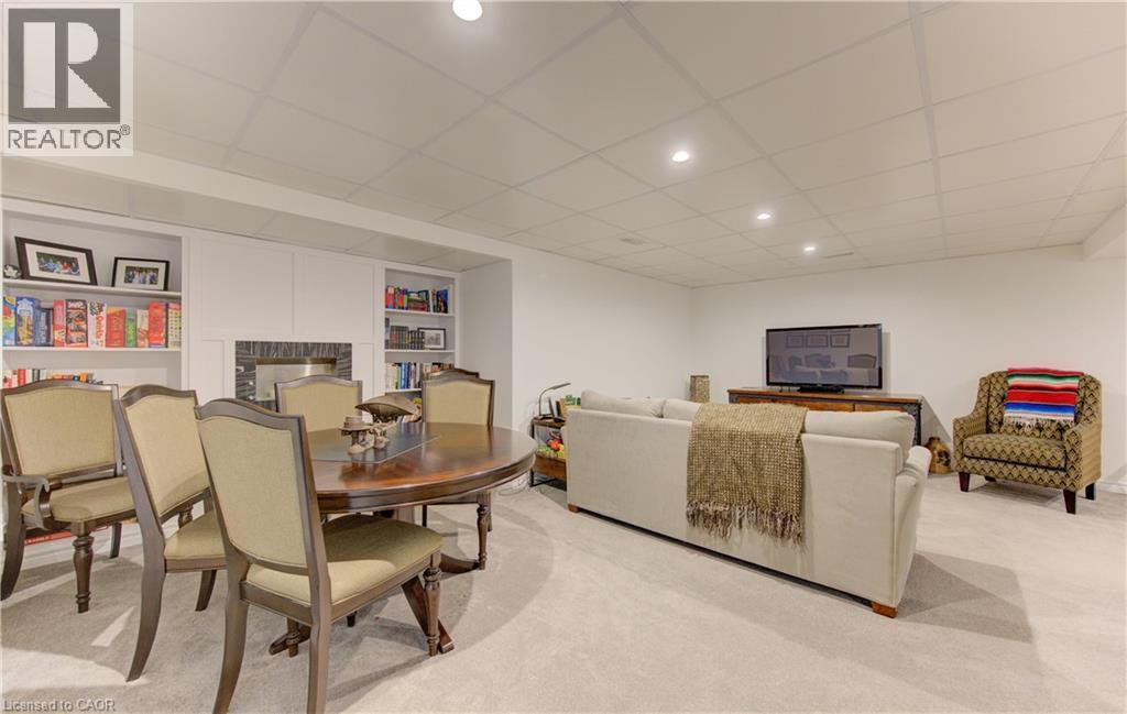 Dining space with a paneled ceiling, built in features, a fireplace, light carpet, and recessed lighting - 306 Roxton Drive, Waterloo, ON - Indoor