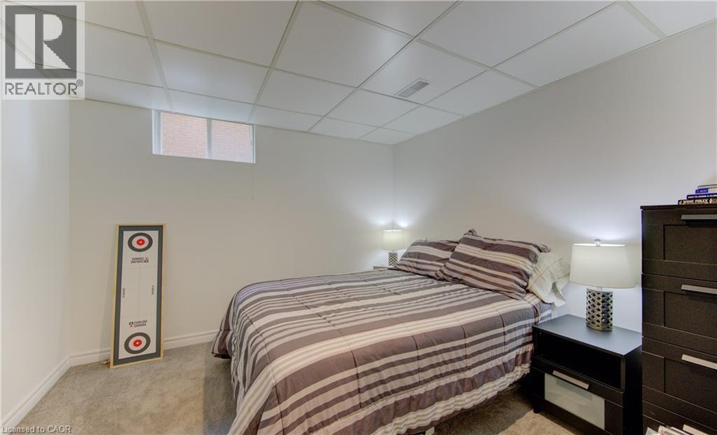 Bedroom featuring a paneled ceiling and light colored carpet - 306 Roxton Drive, Waterloo, ON - Indoor Photo Showing Bedroom