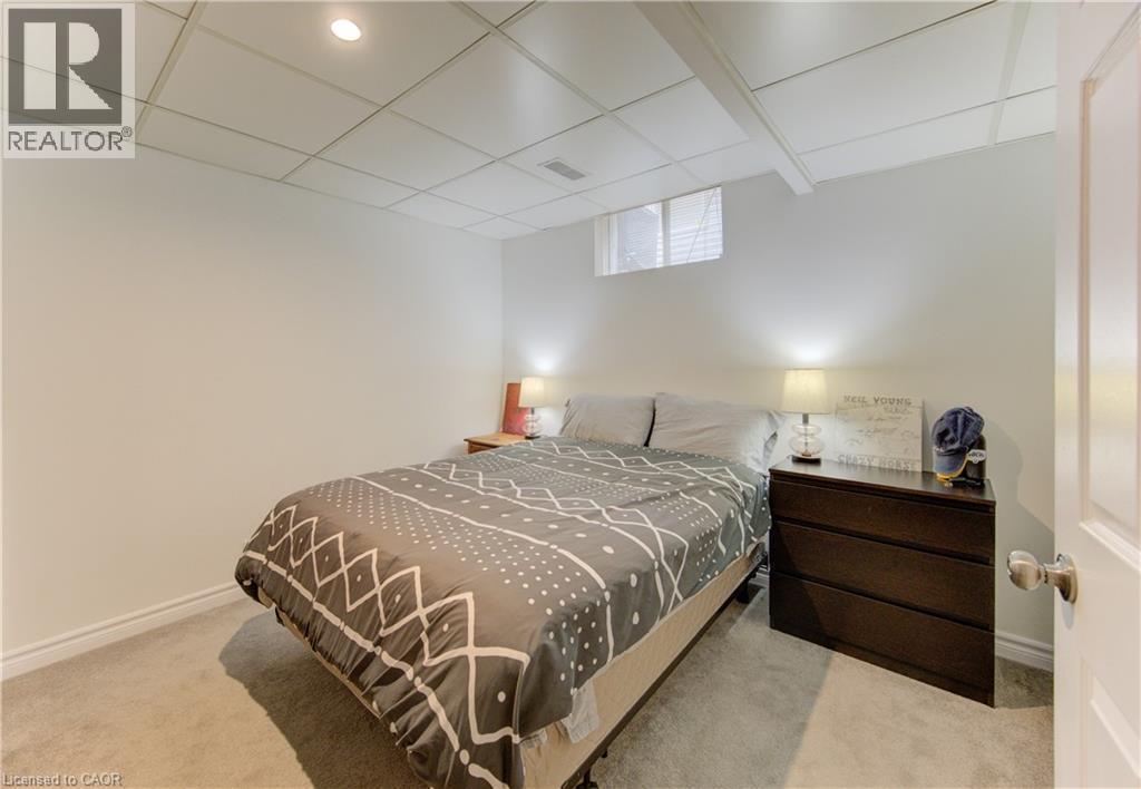 Bedroom with light colored carpet and a drop ceiling - 306 Roxton Drive, Waterloo, ON - Indoor Photo Showing Bedroom