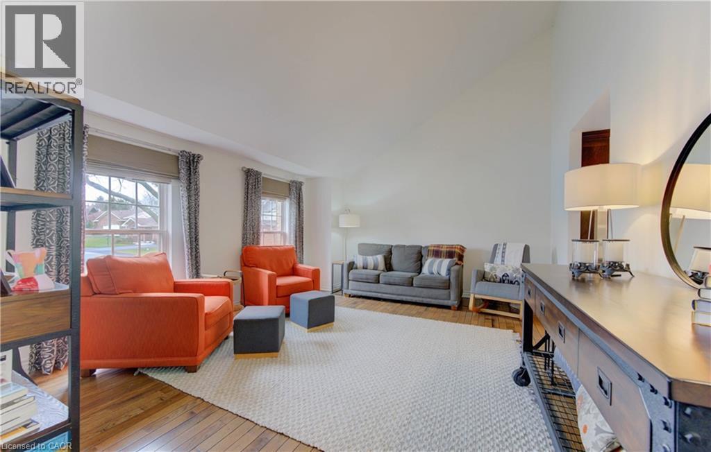 Living room with hardwood / wood-style flooring and lofted ceiling - 306 Roxton Drive, Waterloo, ON - Indoor