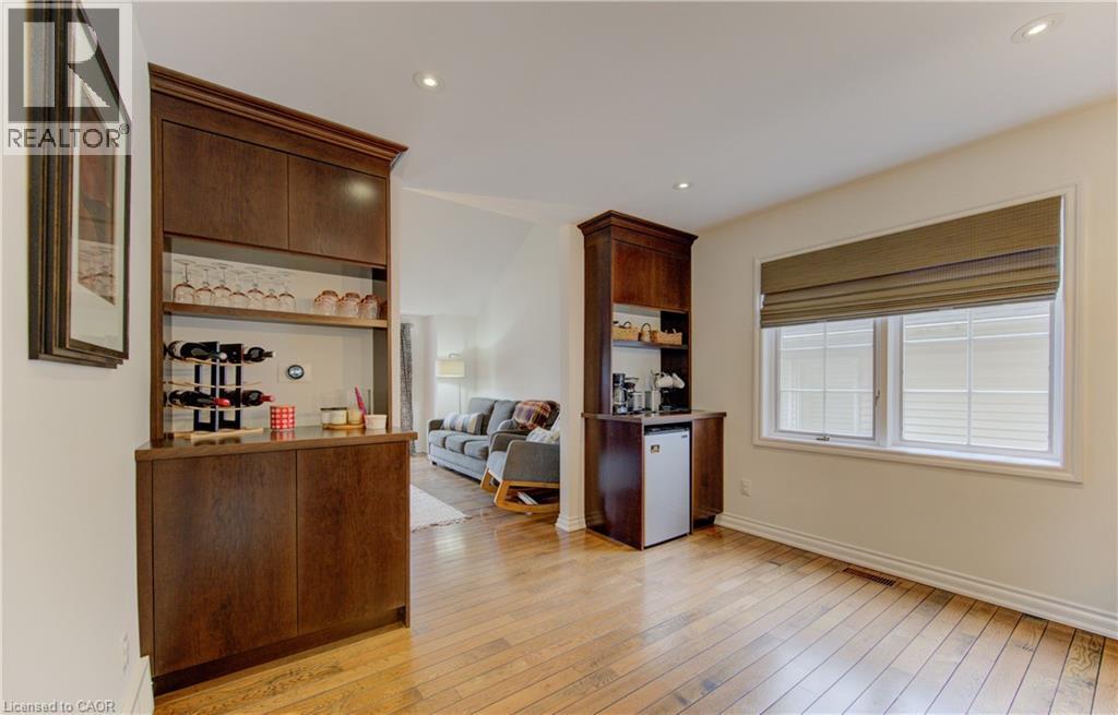 Bar featuring light wood-type flooring, open shelves, recessed lighting, and dark wood finish cabinetry - 306 Roxton Drive, Waterloo, ON - Indoor