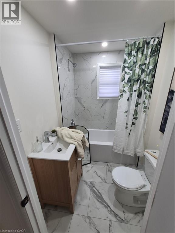 Full bath with vanity, light marble finish floors, and shower / tub combo with curtain - 7 Stapleton Avenue, Hamilton, ON - Indoor Photo Showing Bathroom