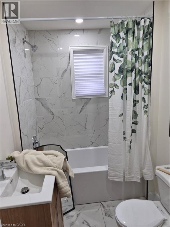 Bathroom featuring vanity, marble finish floors, and shower / bathtub combination with curtain - 7 Stapleton Avenue, Hamilton, ON - Indoor Photo Showing Bathroom