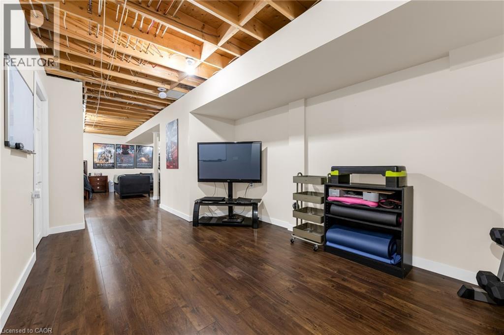 Finished basement with dark wood-type flooring and baseboards - 160 Wallace Avenue S, Welland, ON - Indoor