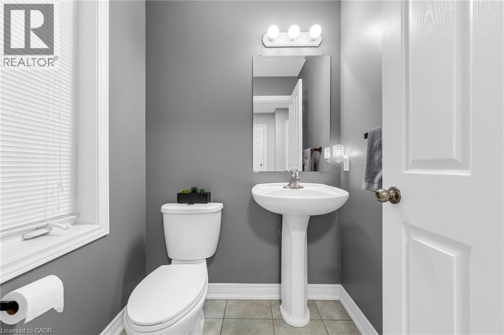Bathroom featuring toilet and light tile patterned floors - 160 Wallace Avenue S, Welland, ON - Indoor Photo Showing Bathroom