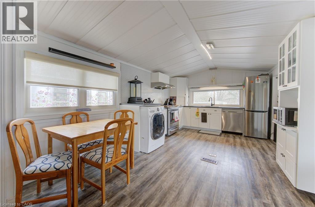 Kitchen featuring white cabinetry, stainless steel appliances, and healthy amount of natural light - 580 Beaver Creek Road Unit# 11, Waterloo, ON - Indoor