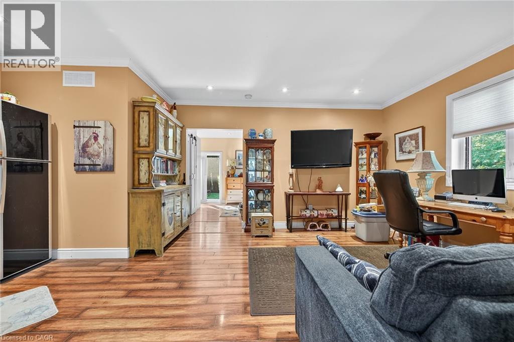 Living area featuring crown molding, an office area, light wood-style floors, and recessed lighting - 5590 Blind Line, Burlington, ON - Indoor